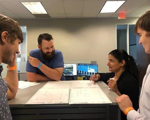 澳门足彩app employees discussing a project in the Dallas office